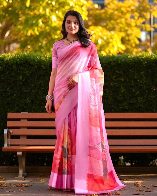 Lady in baby pink Kota cotton saree featuring vibrant floral patterns and check texture.